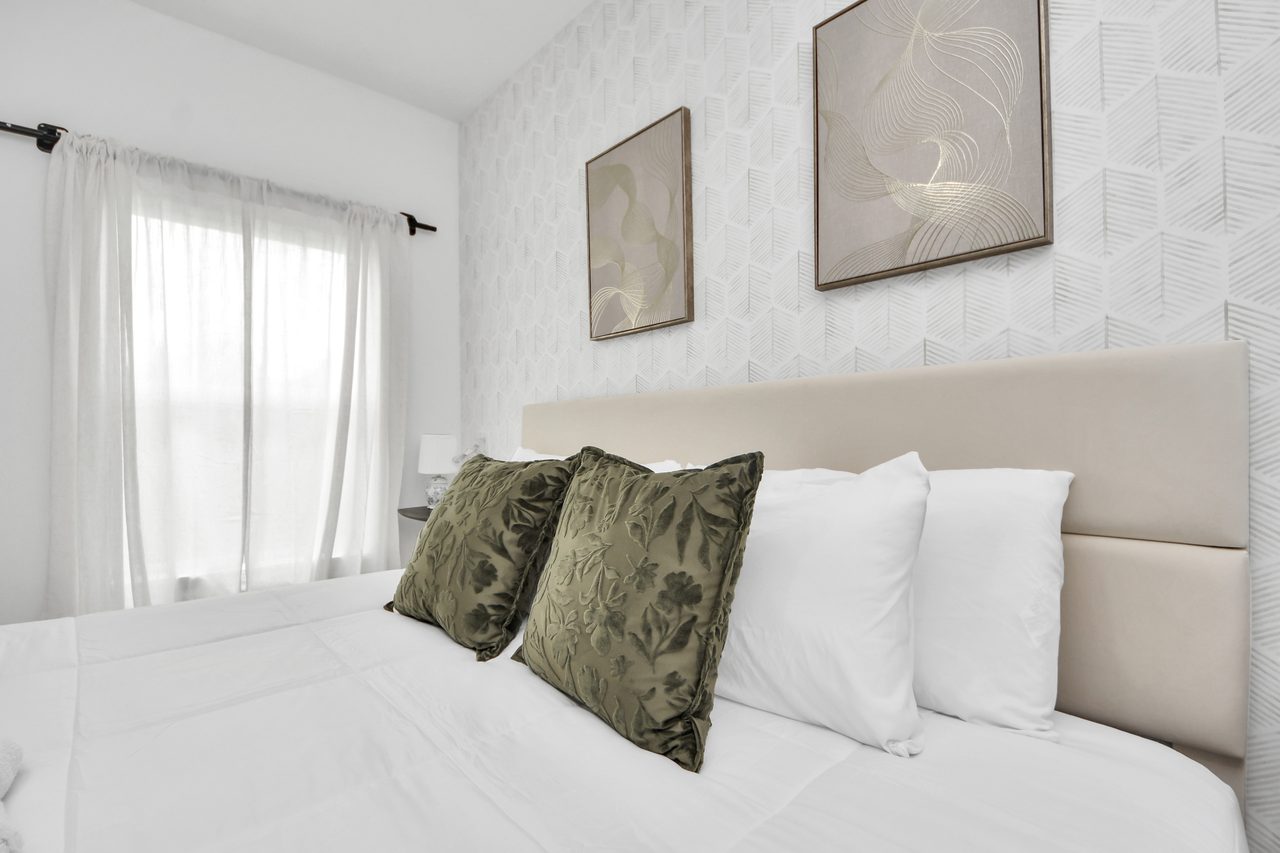 Bedroom with king bed and green accents