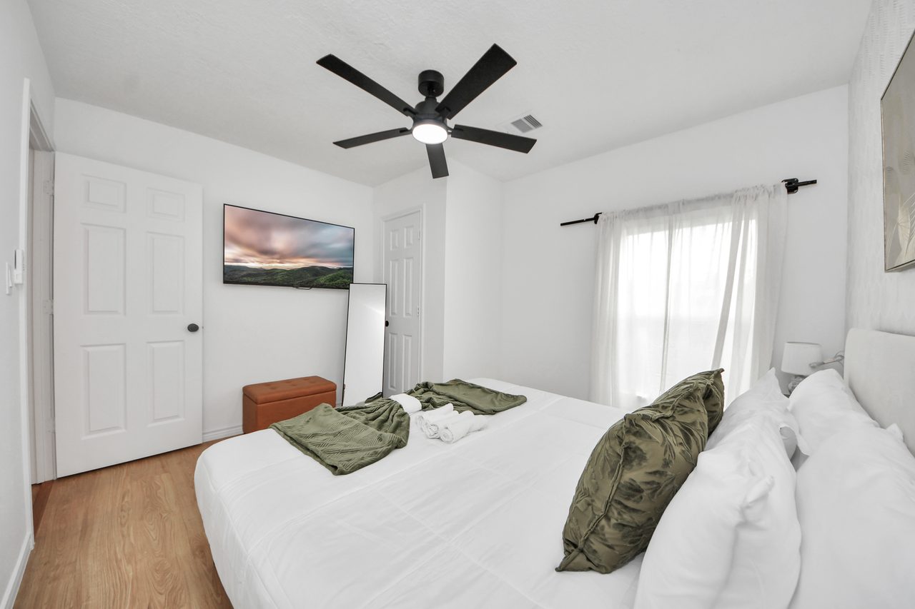Bedroom with wall-mounted TV