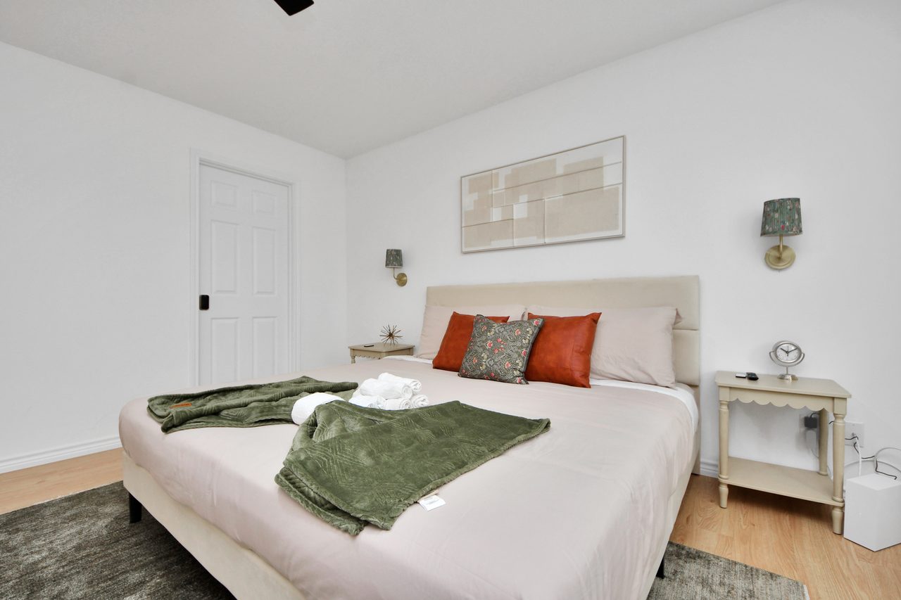 Bedroom with king bed and bright windows