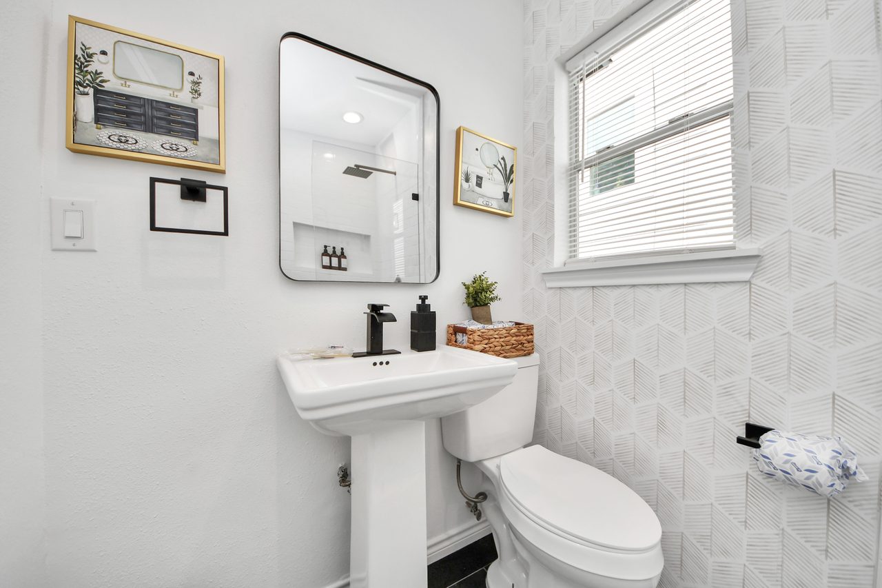 Full bathroom with pedestal sink and toilet